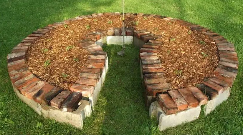 Keyhole raised bed built with reclaimed materials