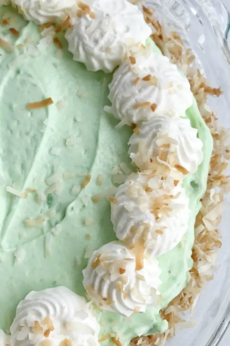 A closeup of a whole yummy coconut pistachio cream pie.