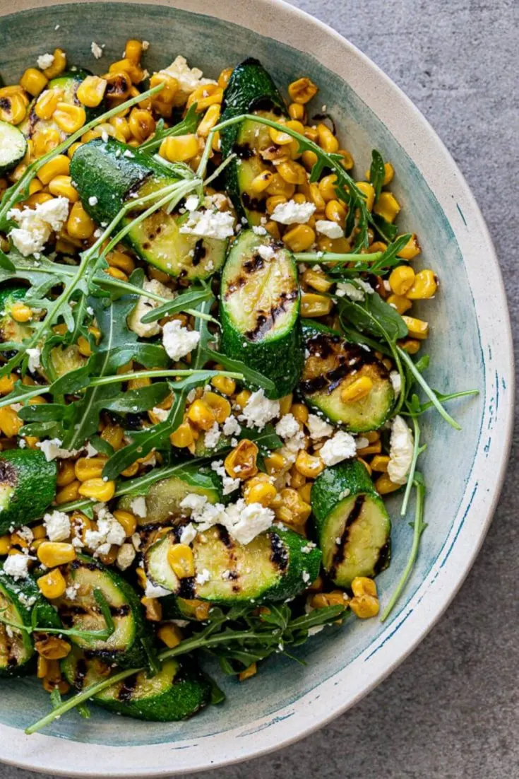 A large bowl of easy corn and grilled zucchini salad.