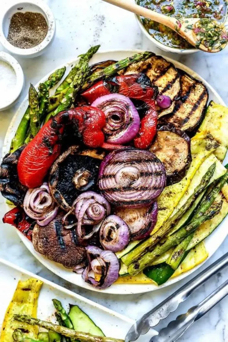A large platter of colorful grilled summer vegetables.