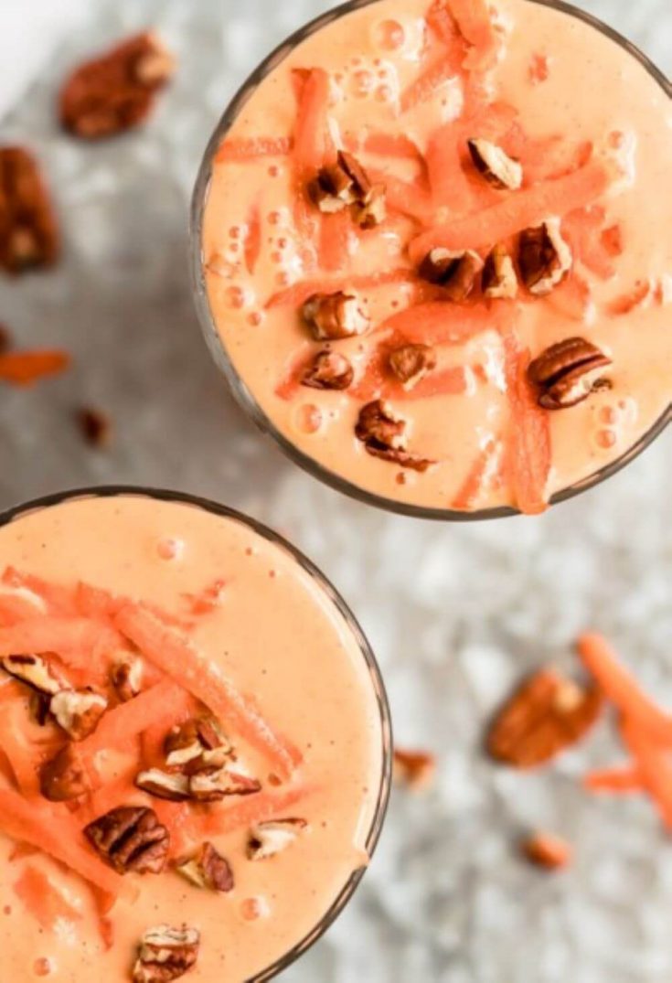 An overhead look at two glasses of healthy carrot cake smoothie.