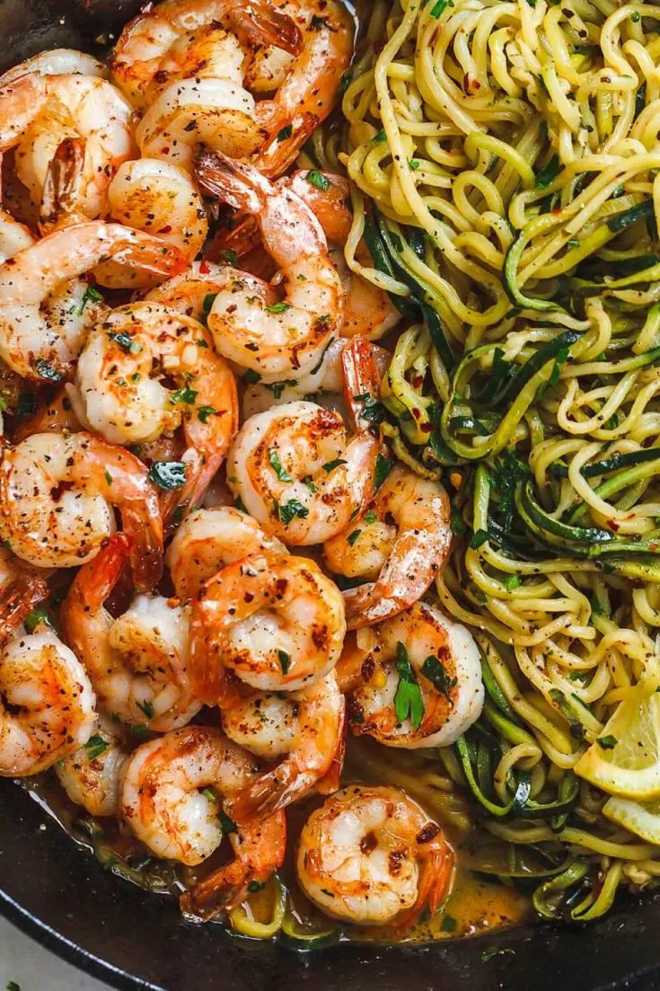 A close-up plate of lemon garlic butter shrimp with zucchini noodles.