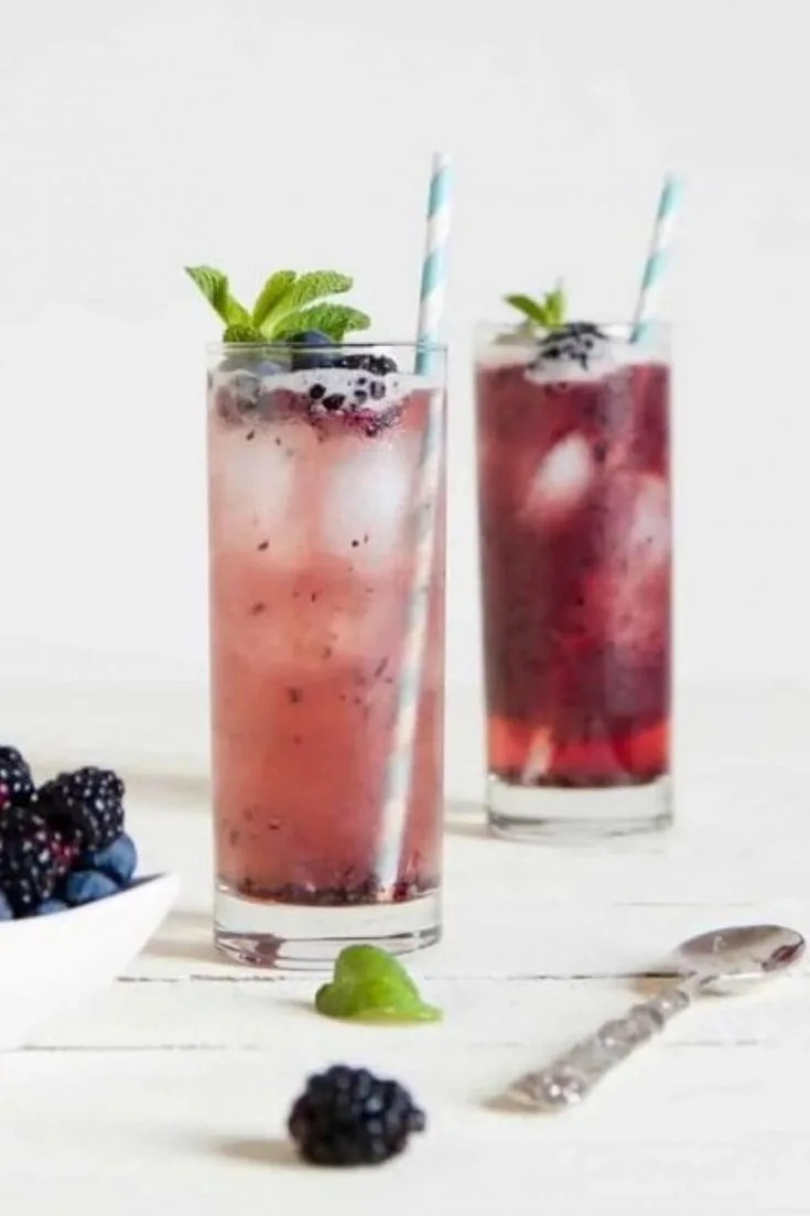 Two full glasses of fruity mixed berry mojito.