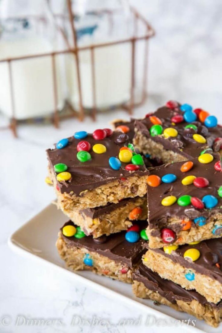 A pile of no-bake monster cookie bars topped with m&ms.