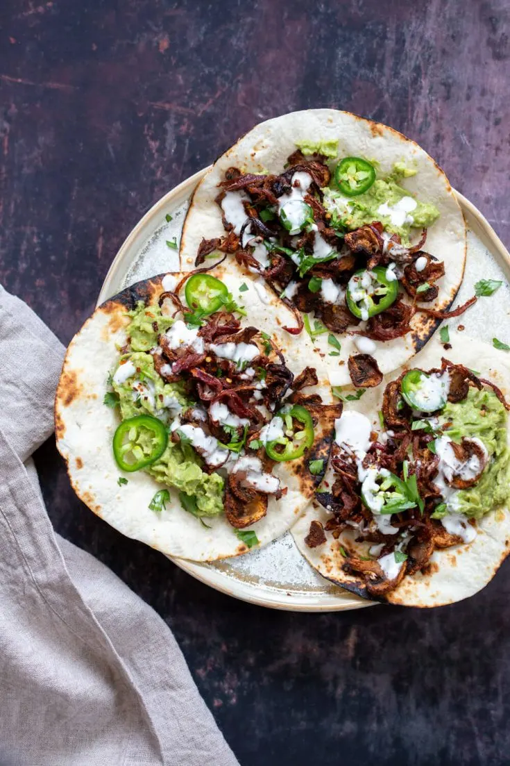 A plate of delicious vegan mushroom carnitas tacos.