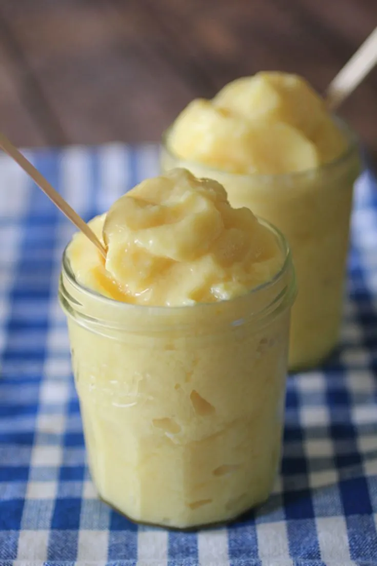 Two mason jars filled with healthy pineapple dole whip.