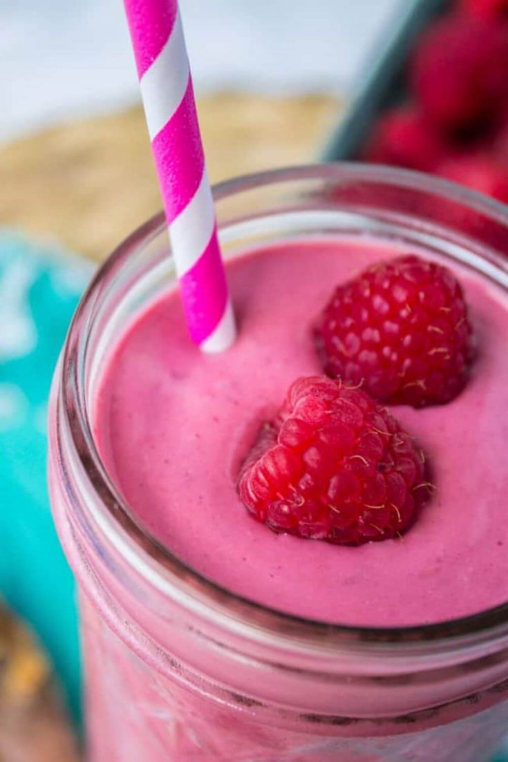 A close-up of raspberry peanut butter smoothie in a mason jar.