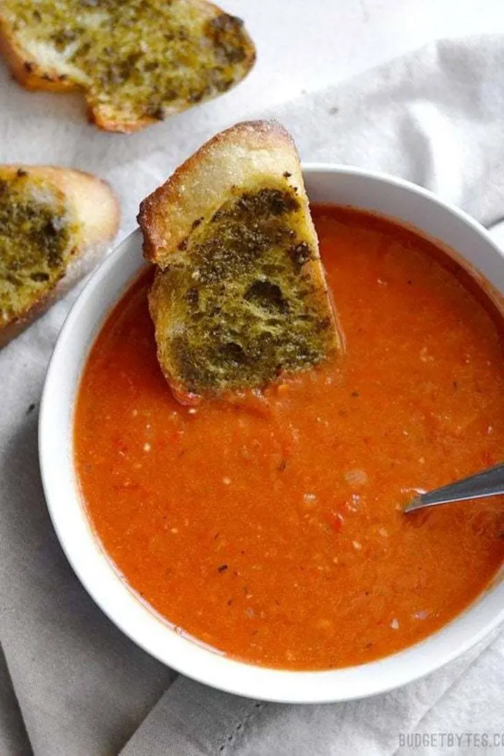 A large bowl of roasted red pepper tomato soup.
