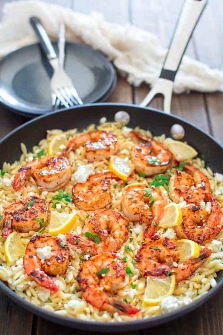 A colorful skillet full of easy orzo with shrimp and feta.
