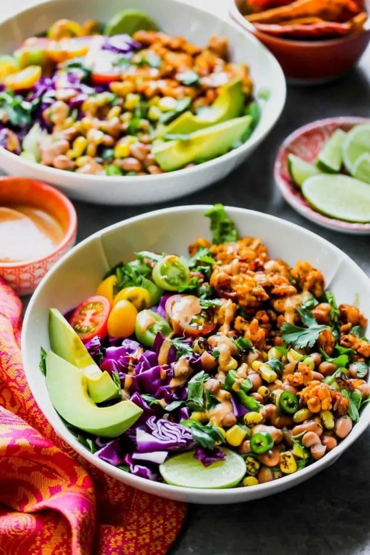 A delicious bowl of southwestern tempeh taco salad with chipotle-tahini dressing.