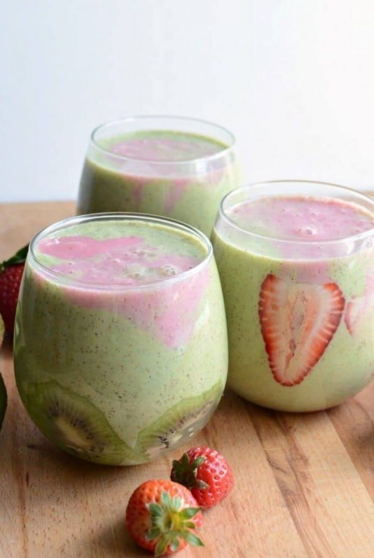 Three short glasses of healthy strawberry kiwi smoothie.