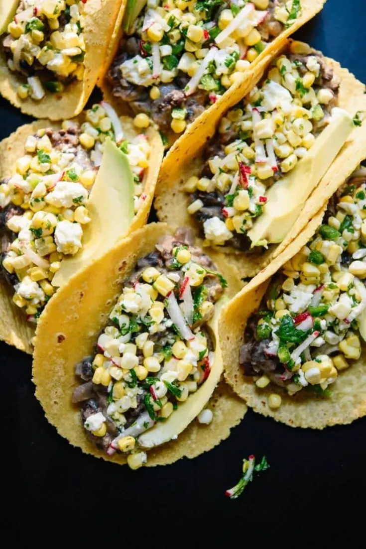 Several loaded sweet corn and black bean tacos.