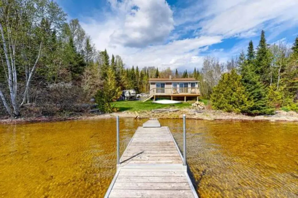 A lakefront cabin at the end of a long dock for rent in Maine.