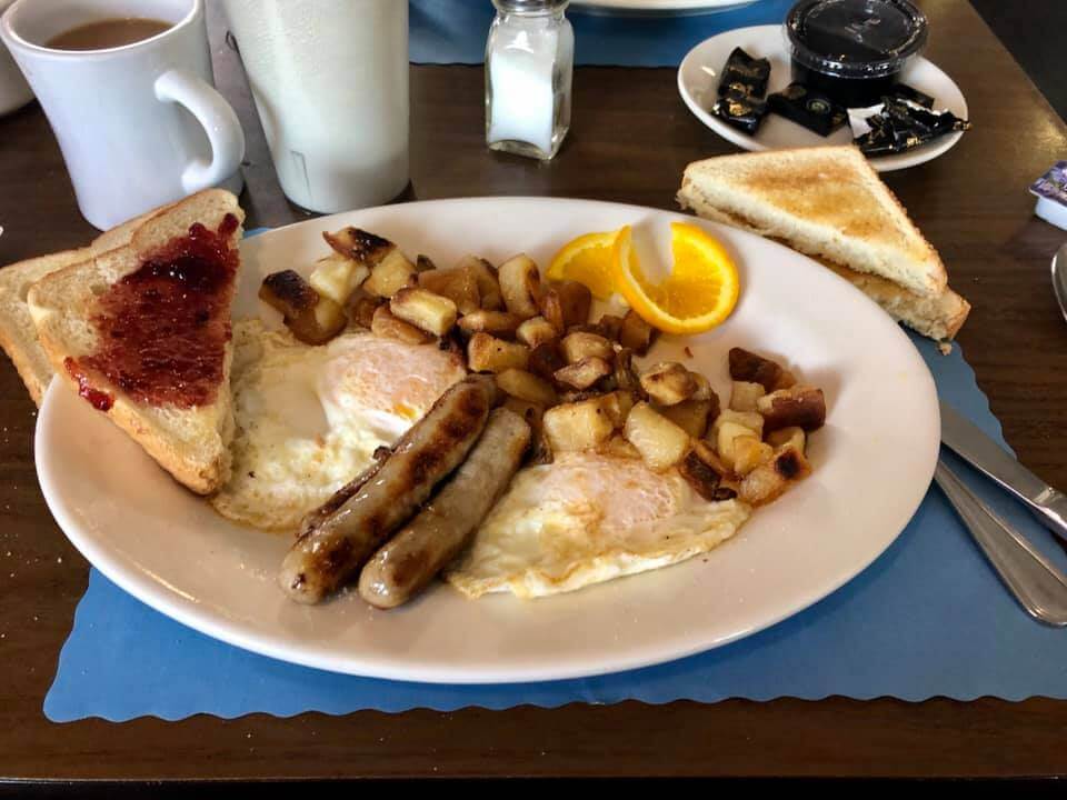A big breakfast plate with eggs, sausage, potatoes, and toast from Chase's Family Restaurant.